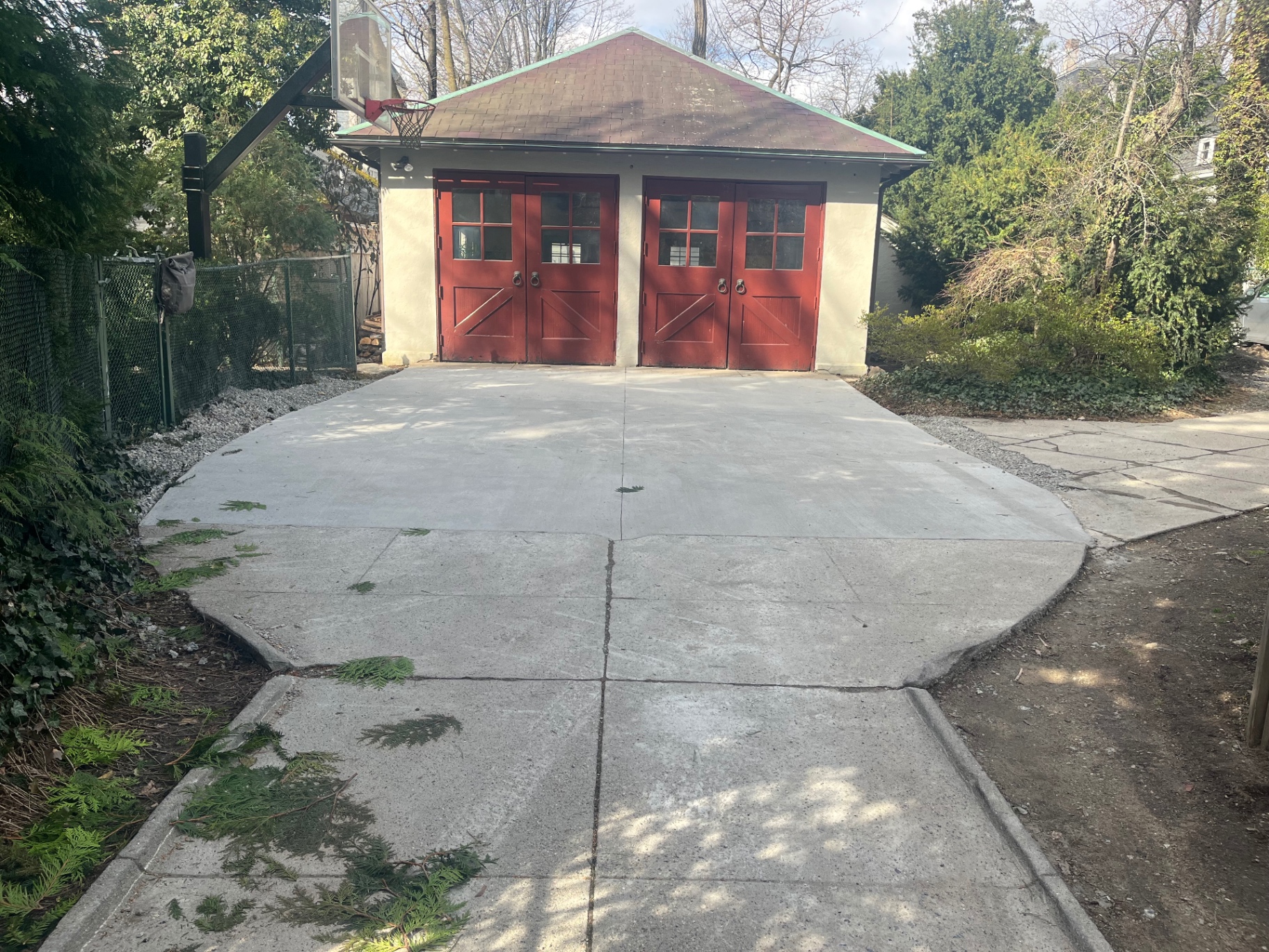 Finished concrete driveway apron in front of a two-car garage