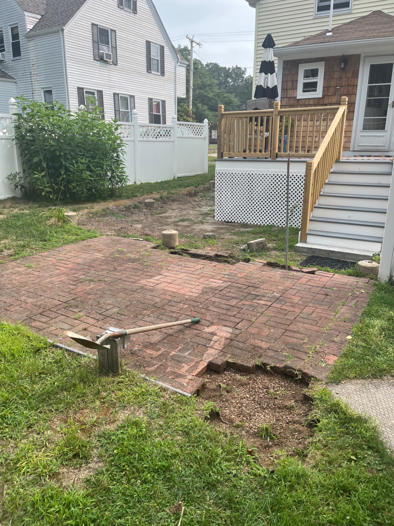Settled brick paver patio being removed and rebuilt