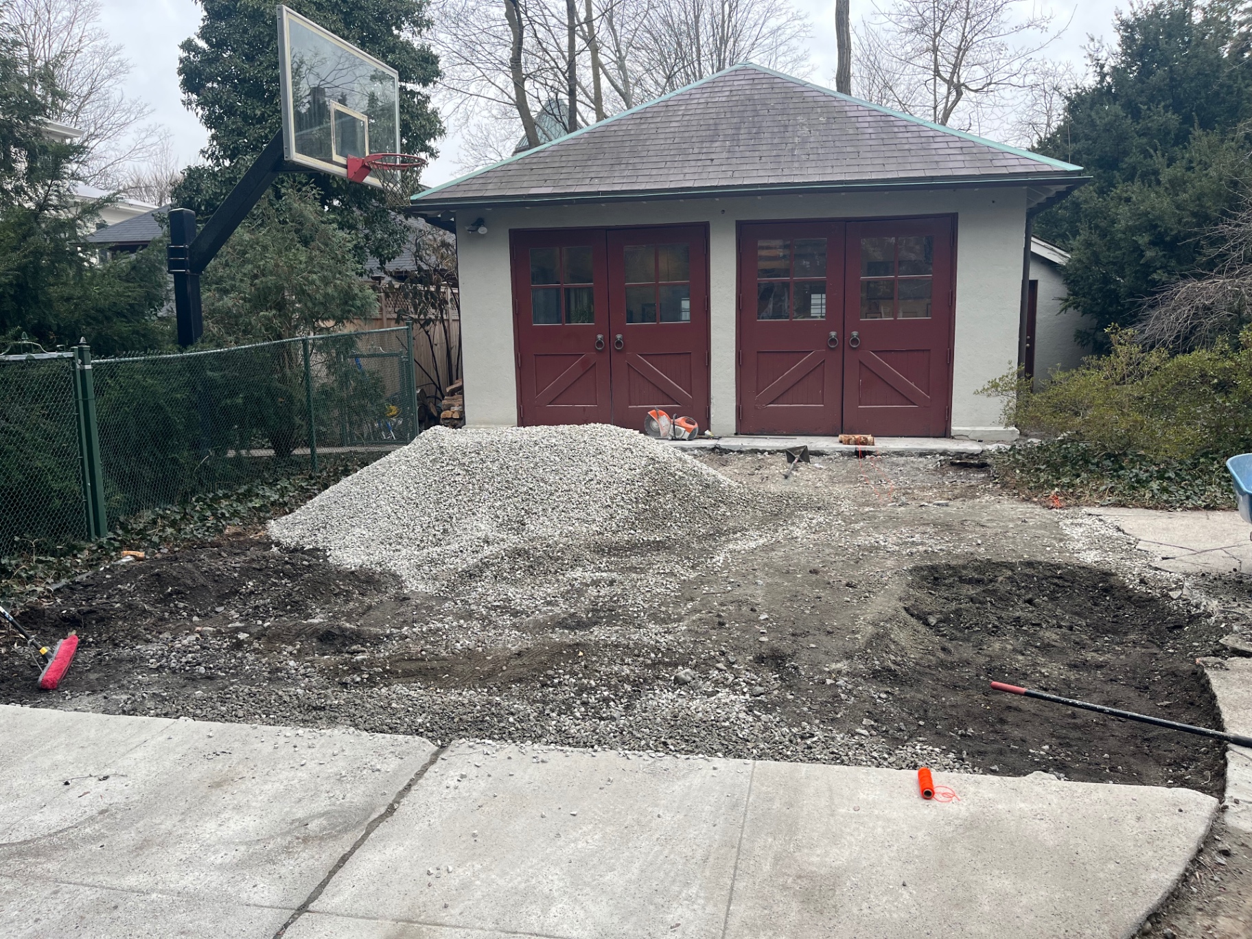 Gravel base prepped in front of a garage for a new concrete driveway