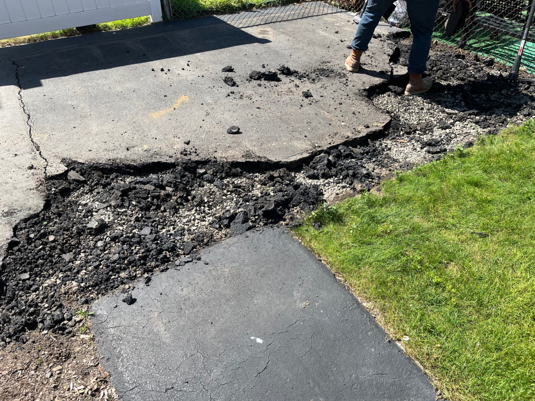 Asphalt driveway demolition before a new concrete pour